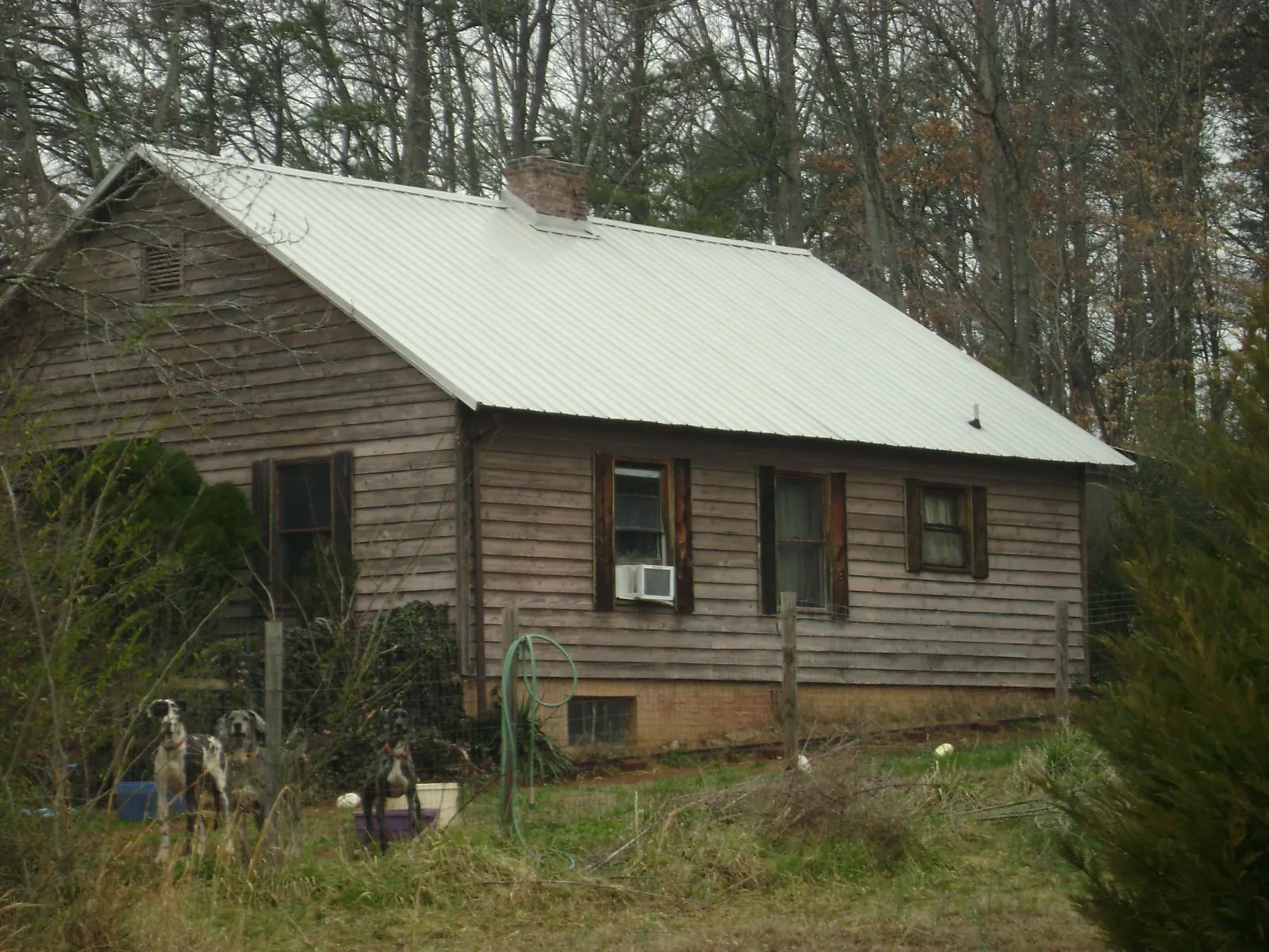 White metal roof on an old wood sided farmhouse, from a Metal Roof Installation job in East Wakefield